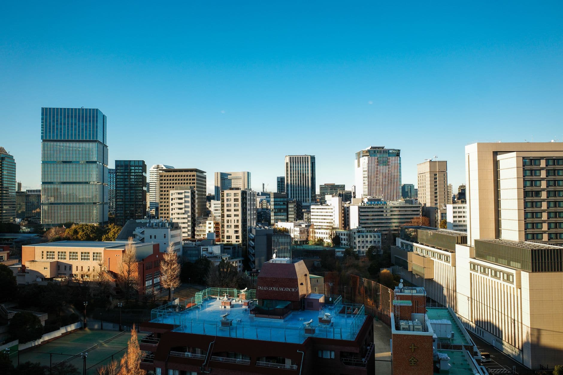Morning view over the office buildings of Chiyoda ward in central Tokyo under a clear sky.